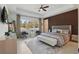 Serene bedroom with a tray ceiling, ample natural light, a neutral color palette and modern decor at 4873 Old Oak Trl, St Cloud, FL 34771