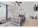 room showcasing fun decorations, a ceiling fan, a window with blue drapes, and colorful racecar-themed accessories at 4873 Old Oak Trl, St Cloud, FL 34771