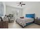 Bright bedroom with neutral walls featuring a desk and a blue bed with striped bedding at 4873 Old Oak Trl, St Cloud, FL 34771