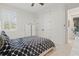 Cozy bedroom with a patterned bed, window with shutters, and double closet doors at 4873 Old Oak Trl, St Cloud, FL 34771