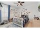 Charming bedroom with playful decor, a crib, and lots of natural light at 4873 Old Oak Trl, St Cloud, FL 34771