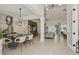 Open-concept dining and living area features modern lighting, tiled floor, and an inviting atmosphere at 4873 Old Oak Trl, St Cloud, FL 34771