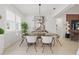 Elegant dining area with modern chandelier, sleek table, and comfortable seating at 4873 Old Oak Trl, St Cloud, FL 34771