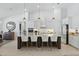 Modern white kitchen features a large island with seating and stainless steel appliances at 4873 Old Oak Trl, St Cloud, FL 34771