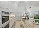 Bright, modern kitchen with white cabinets, stainless steel appliances, and a large island for seating at 4873 Old Oak Trl, St Cloud, FL 34771