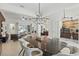 Spacious living area with large windows, stylish lighting, and views of the outdoor living space at 4873 Old Oak Trl, St Cloud, FL 34771