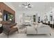 Open living room featuring a modern sectional sofa, stylish decor, and views of the outdoor living space at 4873 Old Oak Trl, St Cloud, FL 34771