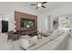 Bright living room with an accent wall, modern furniture, and expansive windows offering natural light at 4873 Old Oak Trl, St Cloud, FL 34771