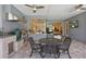 Covered outdoor patio with a built-in grill, a green egg smoker, and a dining table with wrought iron chairs at 4873 Old Oak Trl, St Cloud, FL 34771