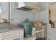 Outdoor kitchen featuring a grill, green egg smoker, sink, and granite countertops at 4873 Old Oak Trl, St Cloud, FL 34771