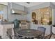 Covered outdoor kitchen with built-in grill, sink, and stone countertops at 4873 Old Oak Trl, St Cloud, FL 34771