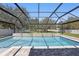 Beautiful backyard showcasing a sparkling pool surrounded by lush landscaping and a fenced perimeter at 4873 Old Oak Trl, St Cloud, FL 34771