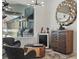 Relaxing sitting area featuring a stylish cabinet, mini-fridge, modern decor, and views of outdoor grill and pool at 4873 Old Oak Trl, St Cloud, FL 34771