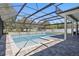 A sparkling screened-in swimming pool and spa, surrounded by a brick patio at 4873 Old Oak Trl, St Cloud, FL 34771