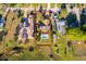 Aerial view of property with pool, solar panels, well-maintained lawn, and proximity to a serene lake at 6051 Twin Lakes Dr, Oviedo, FL 32765