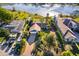 Aerial view of a beautiful home with a well-manicured lawn, mature trees, and a paved driveway at 6051 Twin Lakes Dr, Oviedo, FL 32765