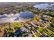 Breathtaking aerial view of a home nestled by a lake, surrounded by lush greenery and trees at 6051 Twin Lakes Dr, Oviedo, FL 32765