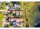 Aerial view showcasing the property boundaries, solar panels, pool, and lush surroundings near the lake at 6051 Twin Lakes Dr, Oviedo, FL 32765