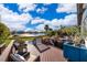 Backyard features a private pool, lake view, patio furniture, and lush landscaping at 6051 Twin Lakes Dr, Oviedo, FL 32765