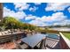 Backyard features a private pool, patio seating, lake view, and lush tropical landscaping at 6051 Twin Lakes Dr, Oviedo, FL 32765