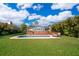 Backyard featuring a private pool, wooden deck, and lush greenery at 6051 Twin Lakes Dr, Oviedo, FL 32765