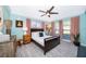 Inviting bedroom offers natural light, light blue walls and wood-look vinyl flooring at 6051 Twin Lakes Dr, Oviedo, FL 32765