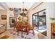 The dining room features a chandelier, travertine floors, and glass sliding doors to the patio at 6051 Twin Lakes Dr, Oviedo, FL 32765