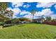 Expansive green lawn and mature trees frame this inviting single-story home with a long driveway at 6051 Twin Lakes Dr, Oviedo, FL 32765
