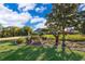 Beautifully landscaped front yard with lush lawn and mature trees leading up to a charming single-story home at 6051 Twin Lakes Dr, Oviedo, FL 32765