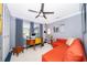 Stylish home office with desk, seating, decor shelving, and orange sectional sofa at 6051 Twin Lakes Dr, Oviedo, FL 32765