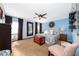 Spacious bedroom features a large bed, natural light, and a mirrored accent wall at 6051 Twin Lakes Dr, Oviedo, FL 32765