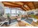 Bright sunroom features vaulted wood ceiling, skylight, and views of the waterfront at 6051 Twin Lakes Dr, Oviedo, FL 32765