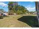 Large backyard with chain link fence and mature trees provides ample green space at 612 California Ave, St Cloud, FL 34769