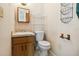 Cozy half bathroom with vanity and standard toilet at 612 California Ave, St Cloud, FL 34769