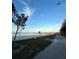 Scenic beach with sandy shore and walking trail under a partly cloudy blue sky at 612 California Ave, St Cloud, FL 34769