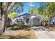 Charming single-story home with white brick, carport, manicured landscaping, and mature trees at 612 California Ave, St Cloud, FL 34769