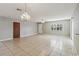 Spacious living room boasting tile floors, ceiling fan, and charming chandelier lighting at 612 California Ave, St Cloud, FL 34769