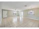Bright, spacious living room featuring tile flooring, a ceiling fan, and natural light at 612 California Ave, St Cloud, FL 34769