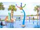 Community splash pad features colorful sprayers, a slide, and waterfront views at 612 California Ave, St Cloud, FL 34769
