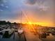 Picturesque sunset at the marina featuring boats and a golden horizon at 612 California Ave, St Cloud, FL 34769