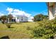 Lush backyard with well-maintained lawn and mature landscaping creates a serene outdoor setting at 6462 Hollyberry Ne Ln, Winter Haven, FL 33881