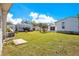 Spacious backyard features a well-maintained lawn, with room to enjoy outdoor activities at 6462 Hollyberry Ne Ln, Winter Haven, FL 33881