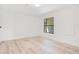 Minimalist bedroom with wood-look flooring and a window at 6462 Hollyberry Ne Ln, Winter Haven, FL 33881