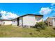 Exterior view features vinyl siding, screen door and central air conditioning unit in a well-maintained yard at 6462 Hollyberry Ne Ln, Winter Haven, FL 33881