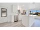 Stylish open kitchen with stainless steel appliances, island, and large windows at 6462 Hollyberry Ne Ln, Winter Haven, FL 33881