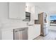 Modern kitchen featuring stainless steel appliances, white cabinetry, and marble countertops at 6462 Hollyberry Ne Ln, Winter Haven, FL 33881
