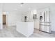 Modern kitchen with stainless steel appliances and sleek white cabinetry at 6462 Hollyberry Ne Ln, Winter Haven, FL 33881