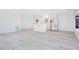 Open-concept living room with stainless steel appliances and white finishes at 6462 Hollyberry Ne Ln, Winter Haven, FL 33881