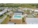A bird's-eye view displays the community's pool, shuffleboard courts, and common area, a hub for recreation and relaxation at 6462 Hollyberry Ne Ln, Winter Haven, FL 33881