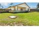 Spacious backyard with a partial view of a quaint fenced in home exterior at 6495 Fall St, St Cloud, FL 34771